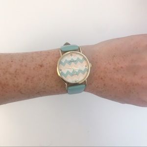 Teal watch with a zig zag clock face